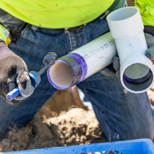 PVC pipe being glued and sealed.